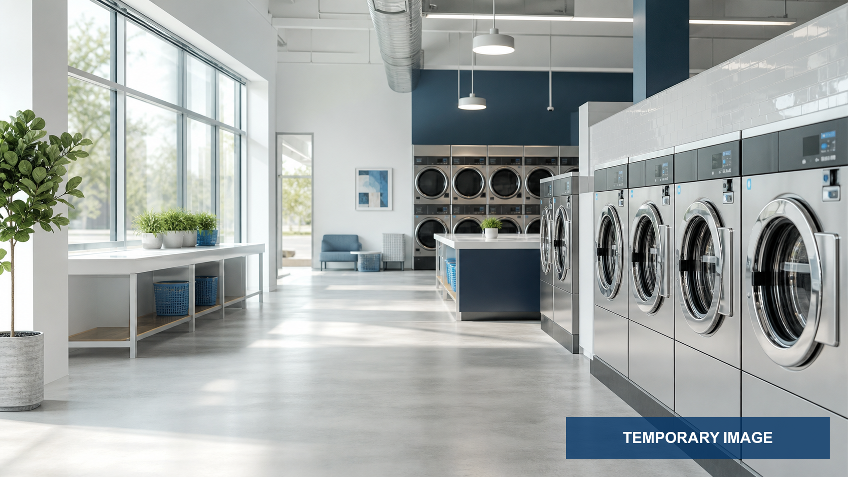 Bright modern laundromat with rows of clean stainless machines